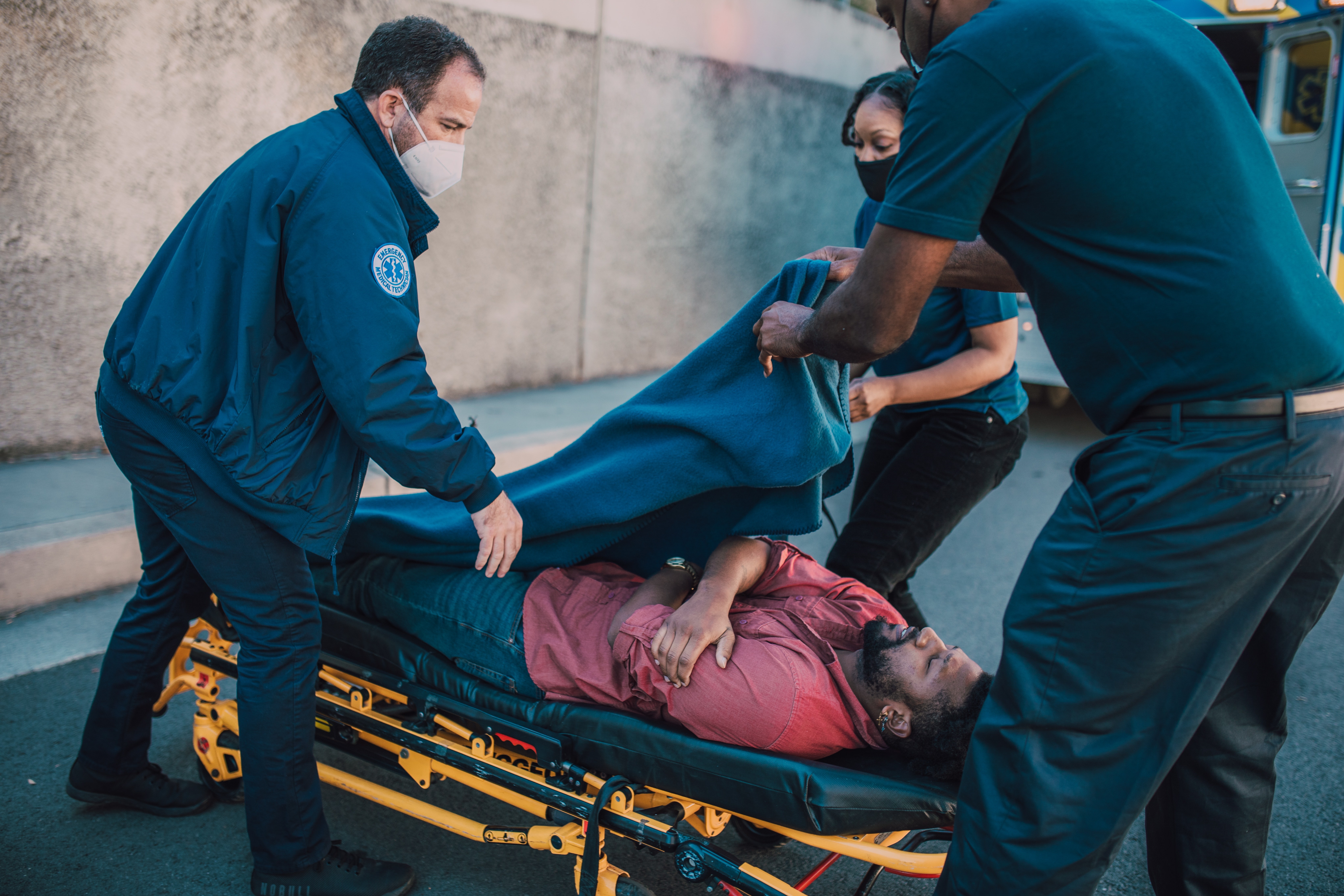 EMS team helping a patient on a stretcher