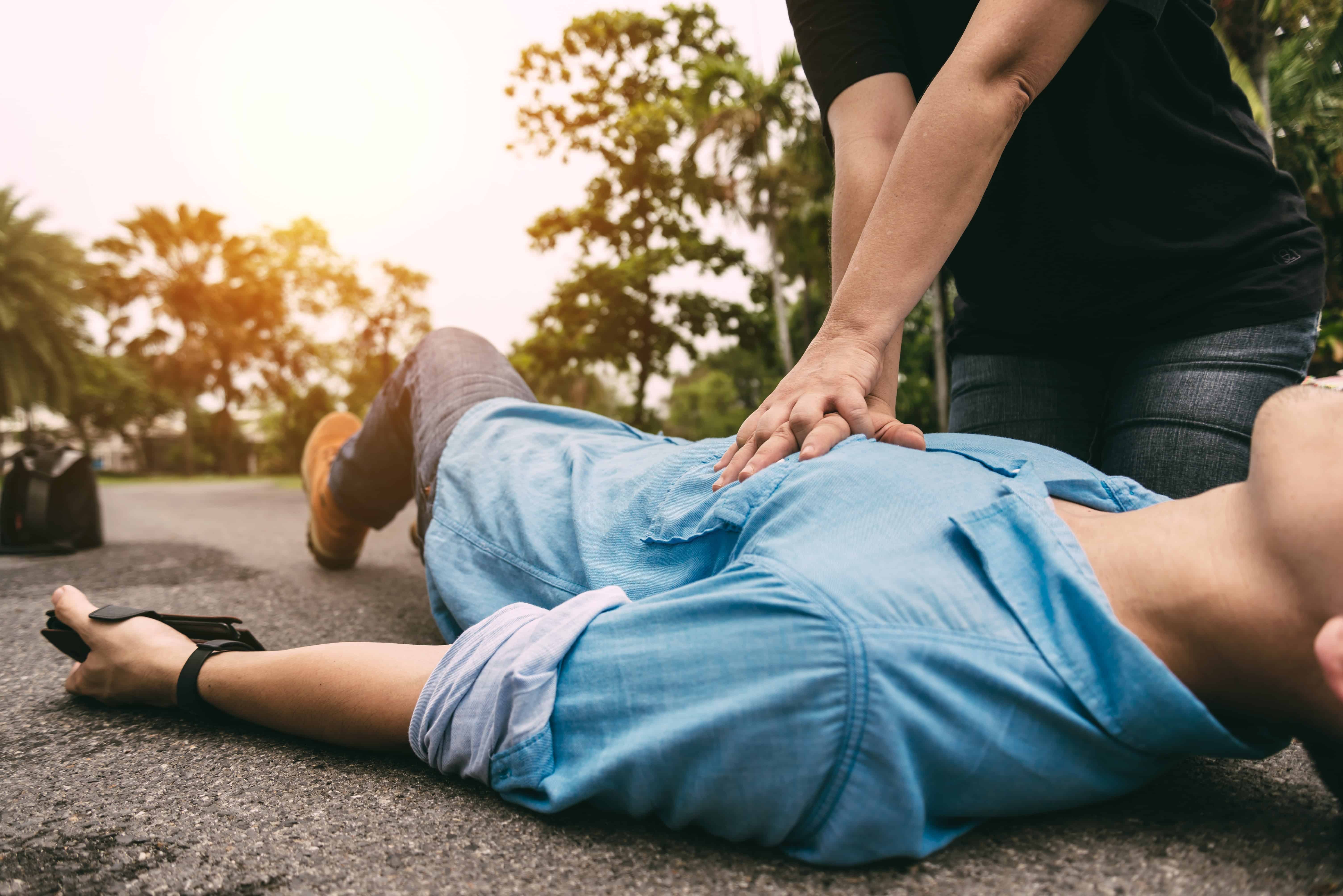 Citizen performing CPR on a man