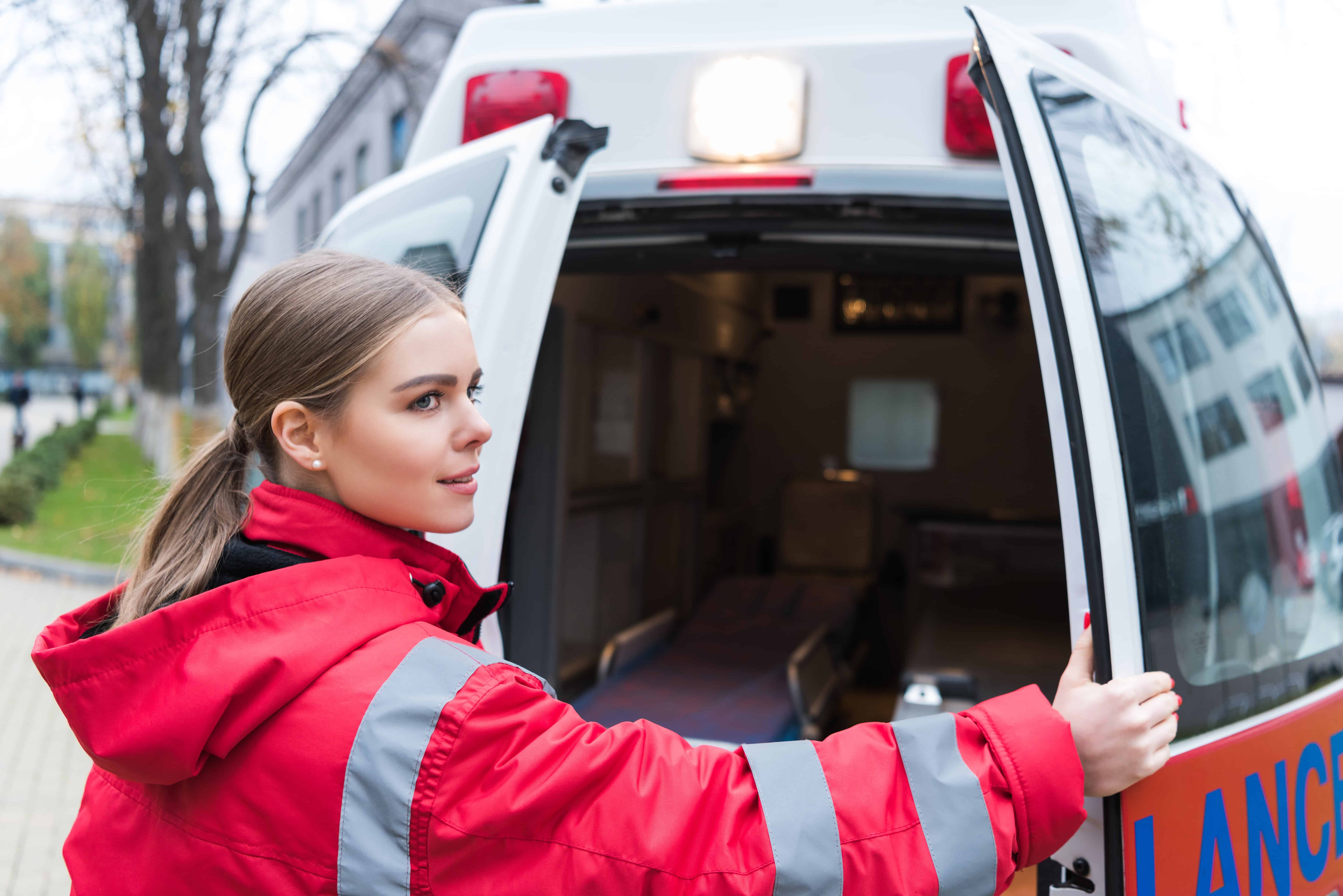 Young EMT opening the ambulance doors