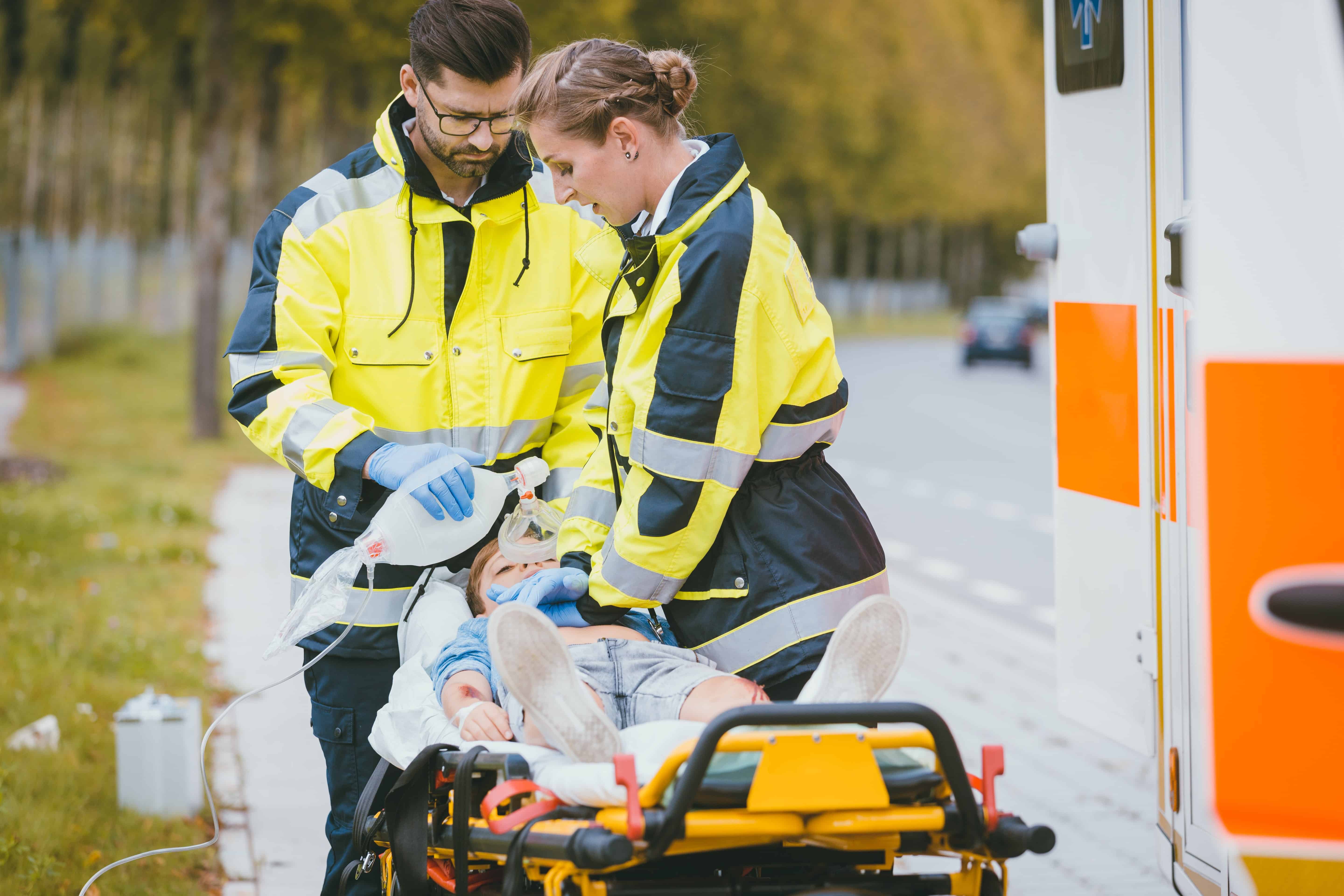 EMS professionals helping a child at the scene of an accident