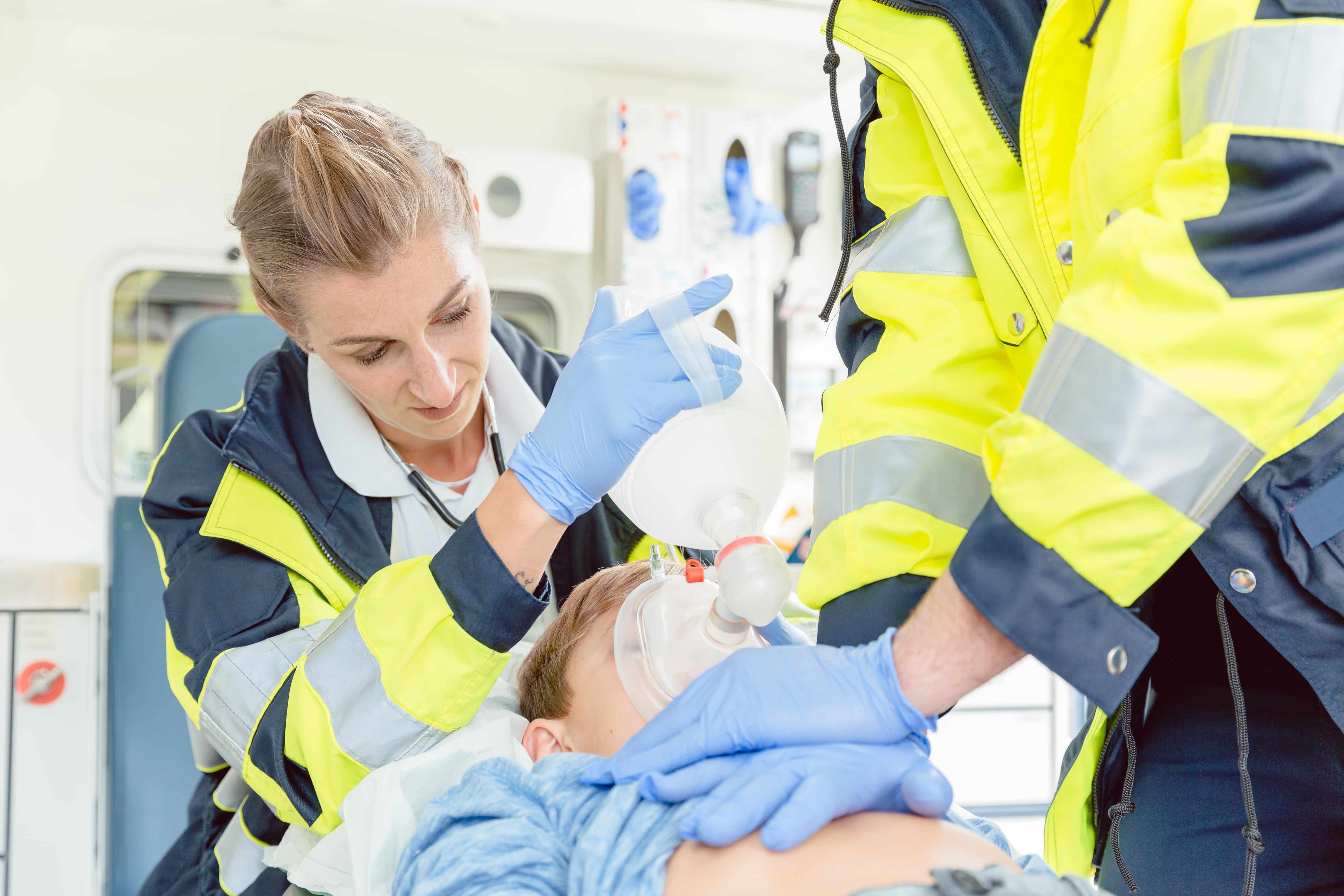 EMS professionals helping a child patient