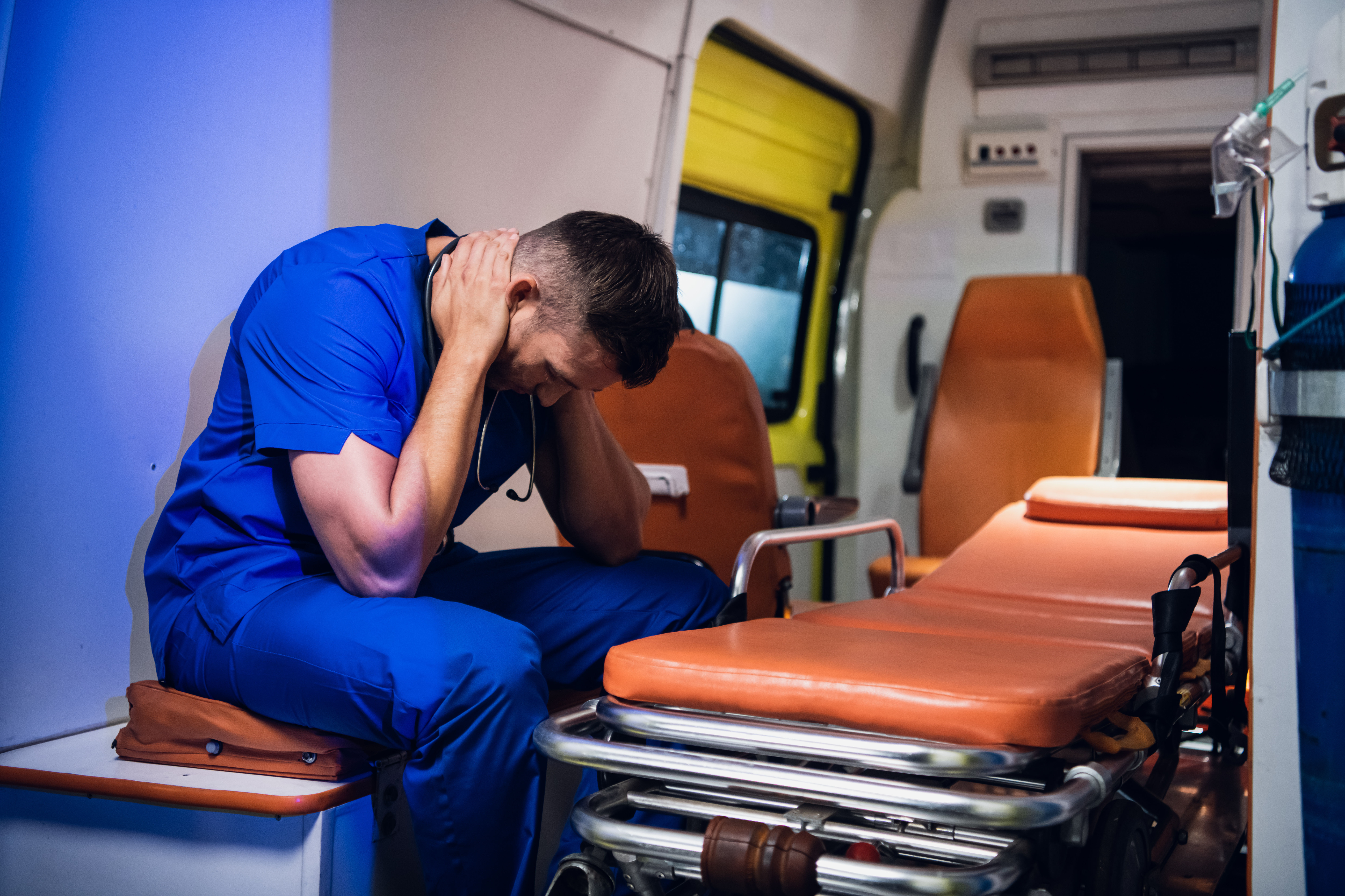 Exhausted EMS professional in an empty ambulance