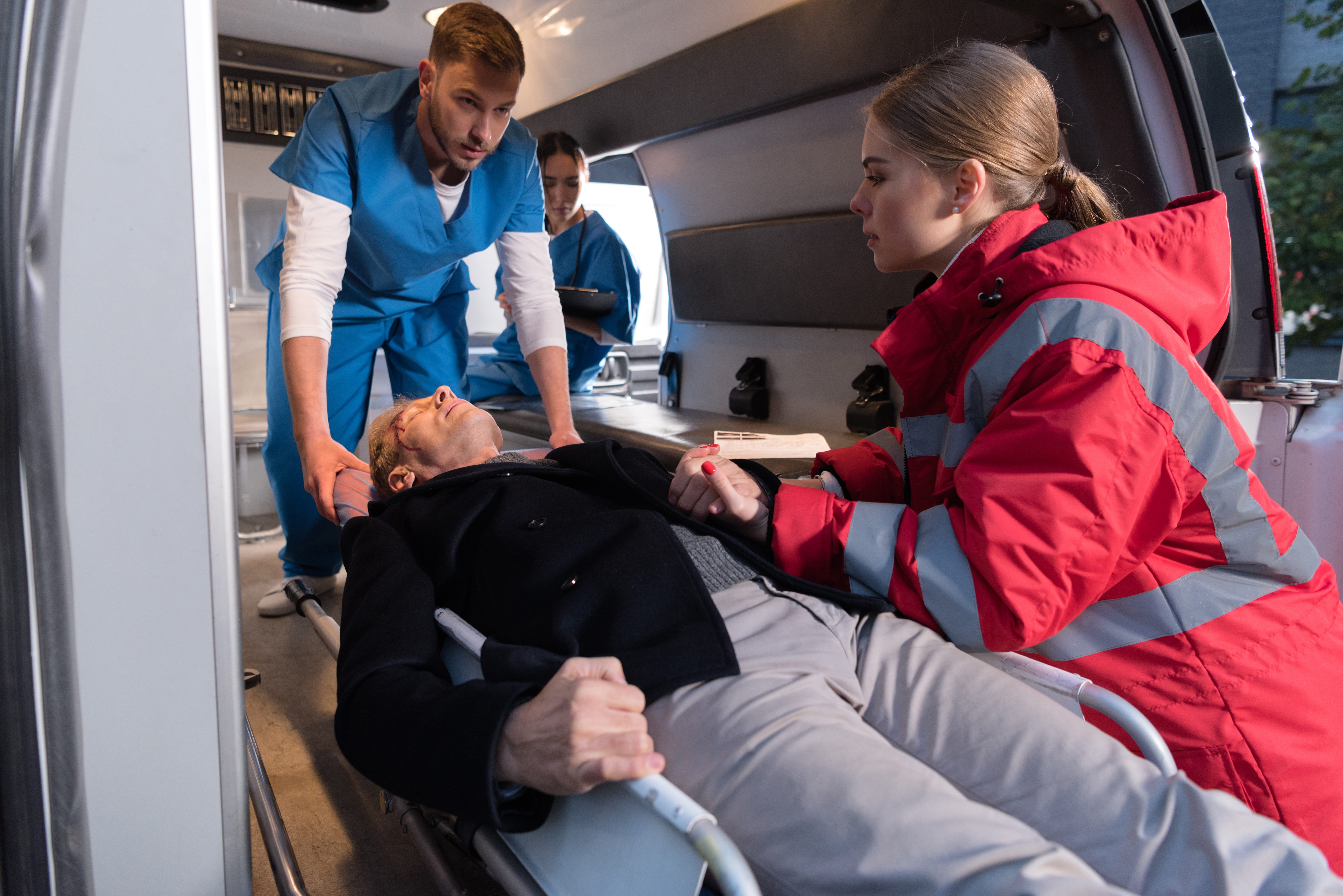 EMS team moving a wounded man