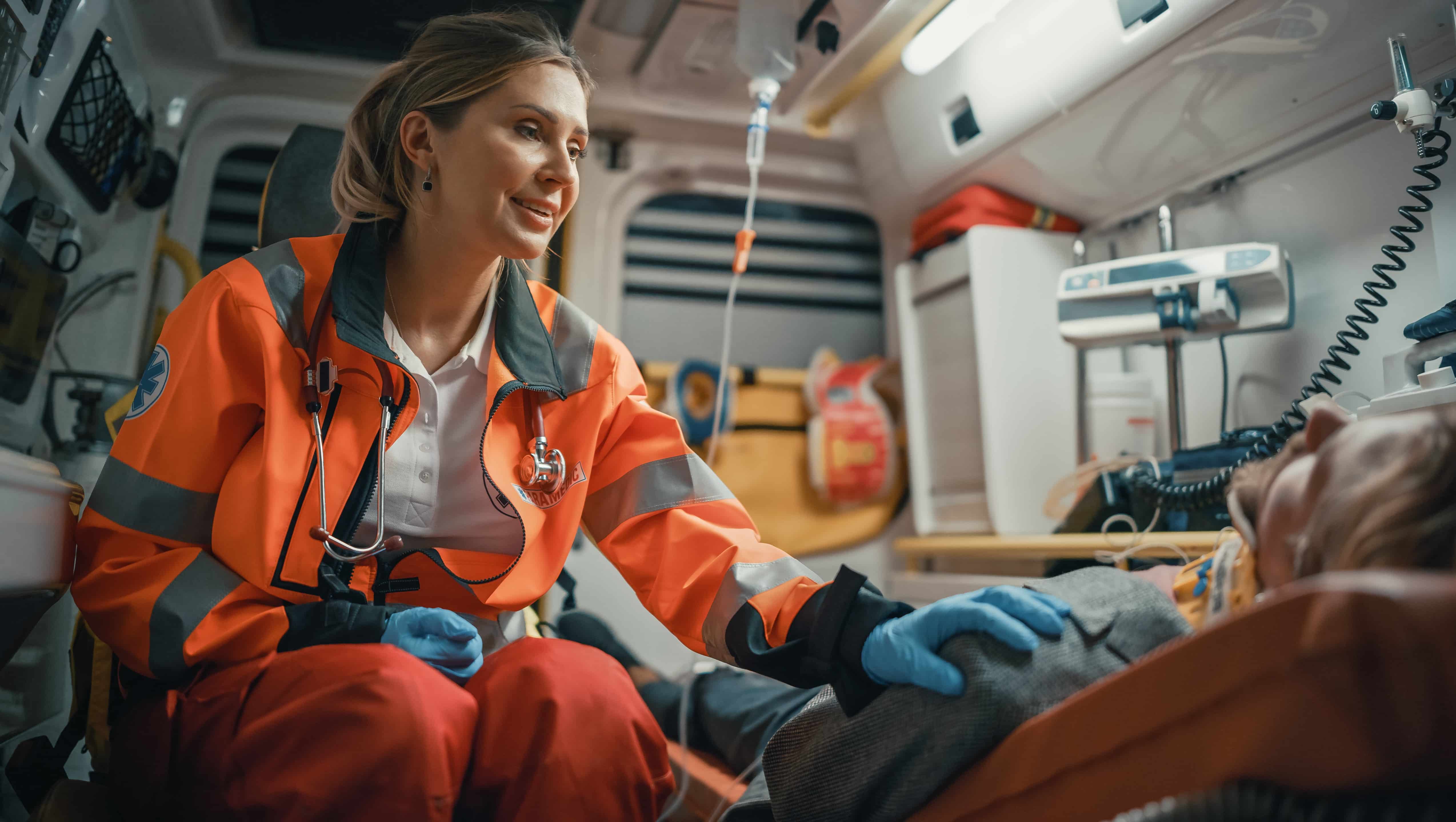 Smiling EMS professional comforting a person