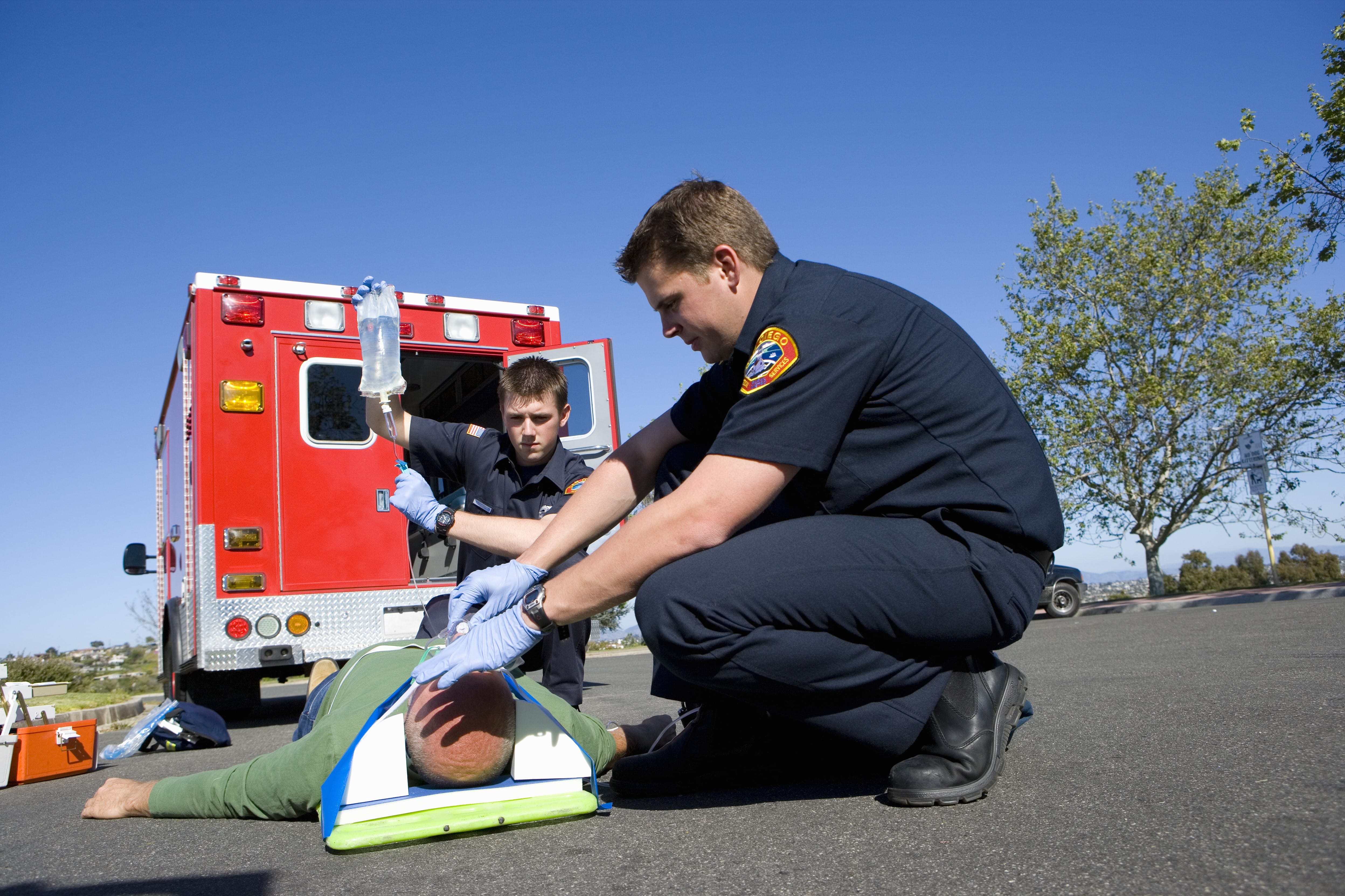 EMS team stabilizing a man on the road