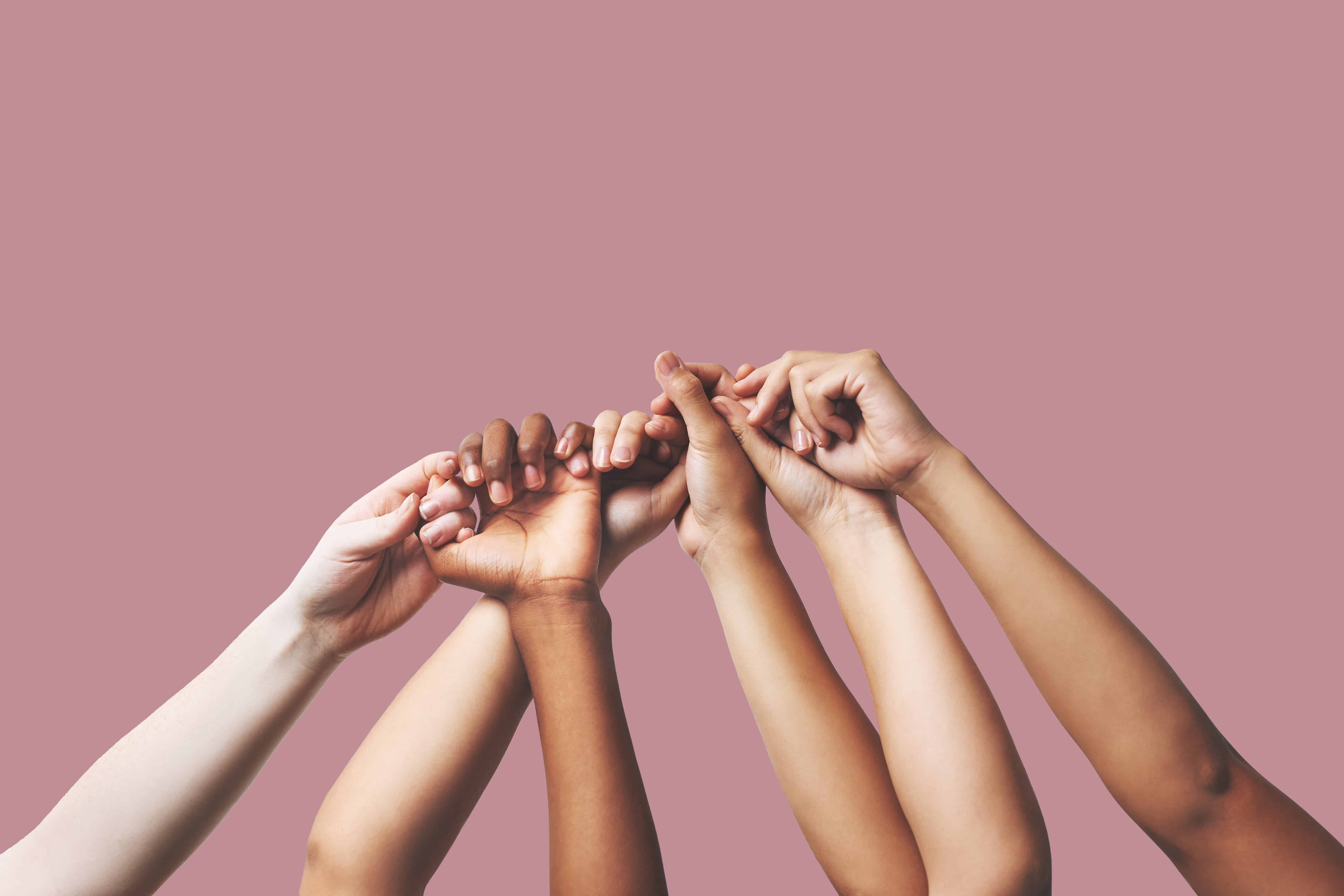 Diverse group of hands joined in support