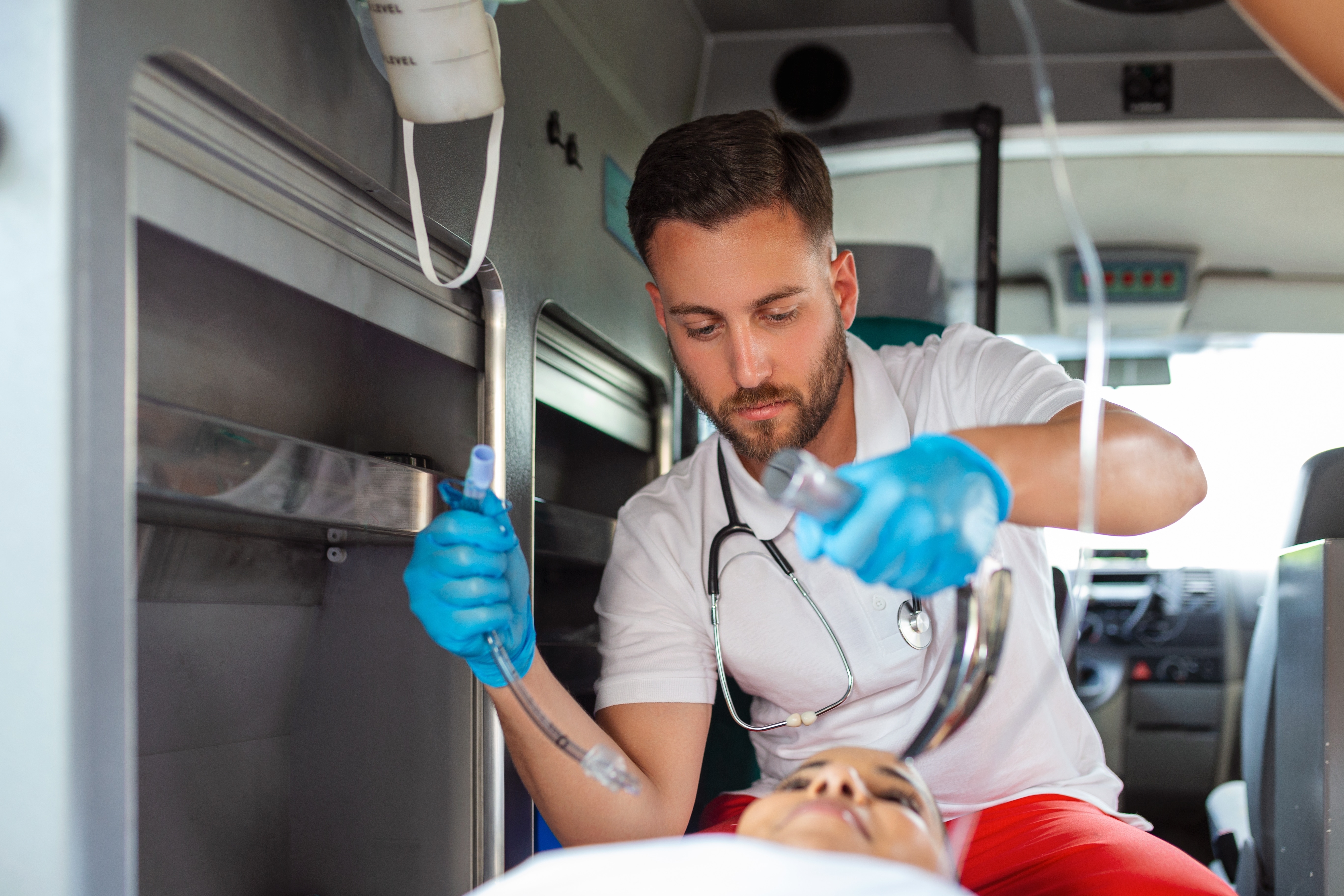 Male EMS professional stabilizing a woman