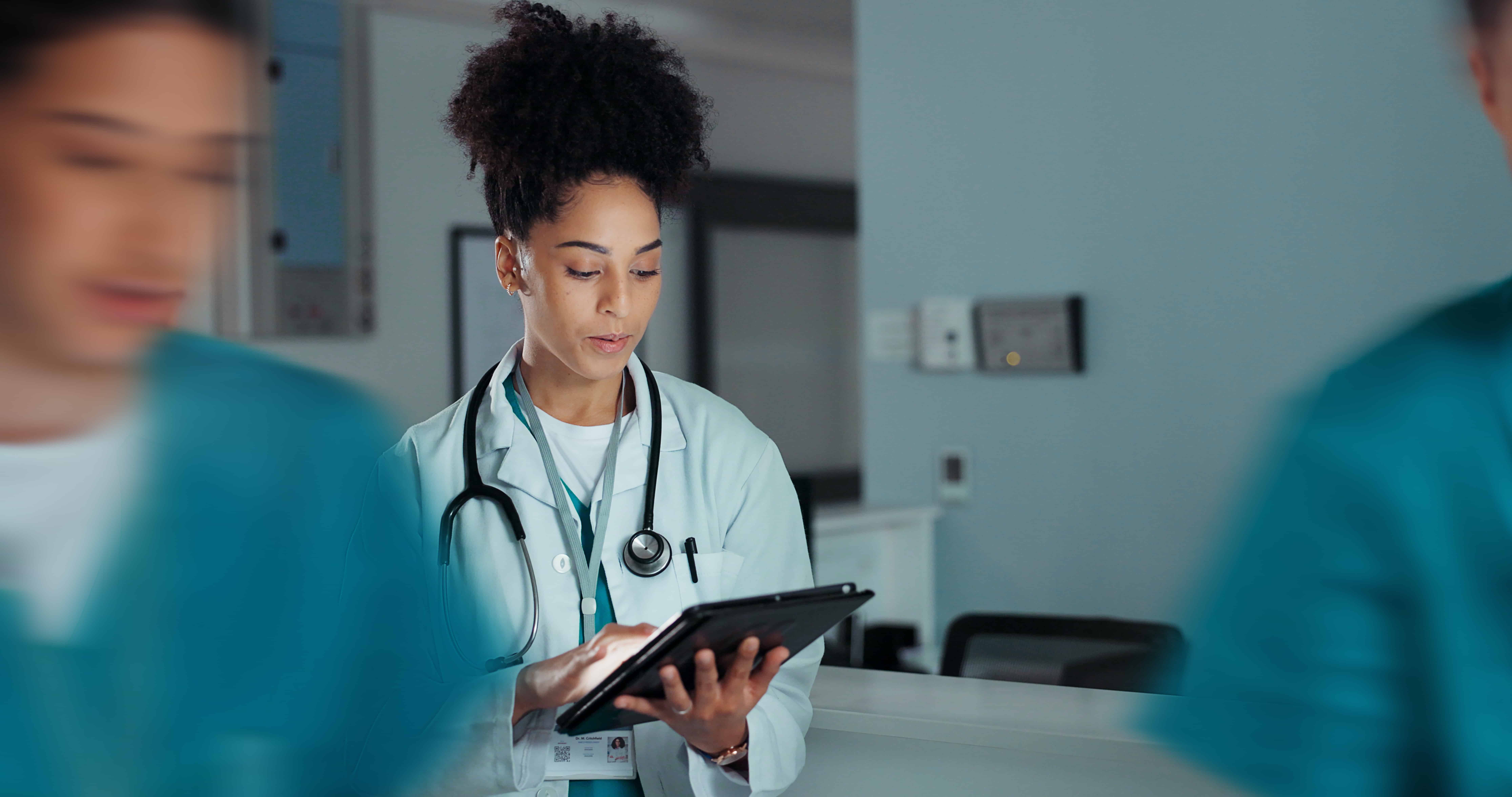 African-American nurse using a tablet in a hospital
