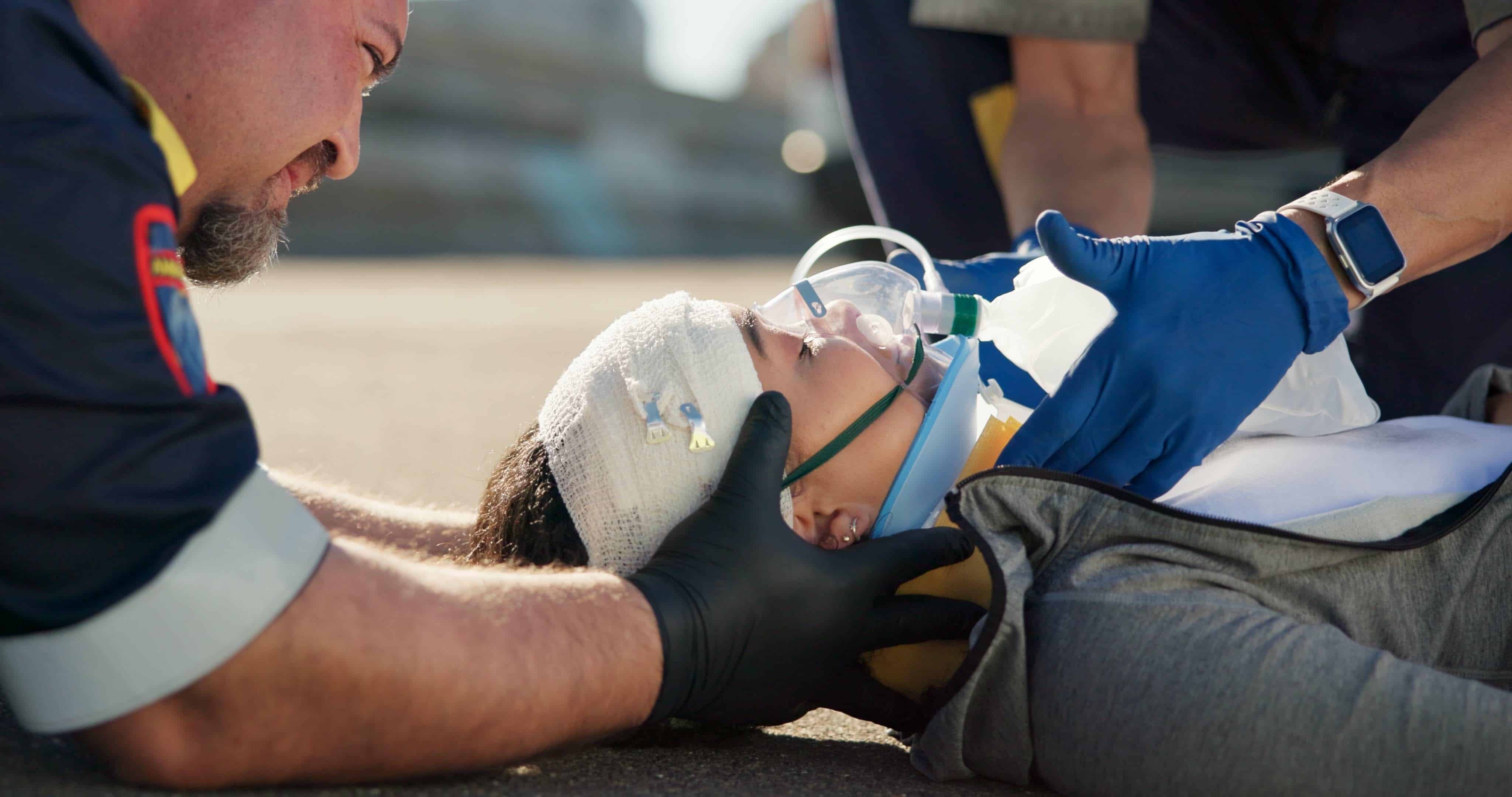 Close up of EMS professionals stabilizing a car crash victim