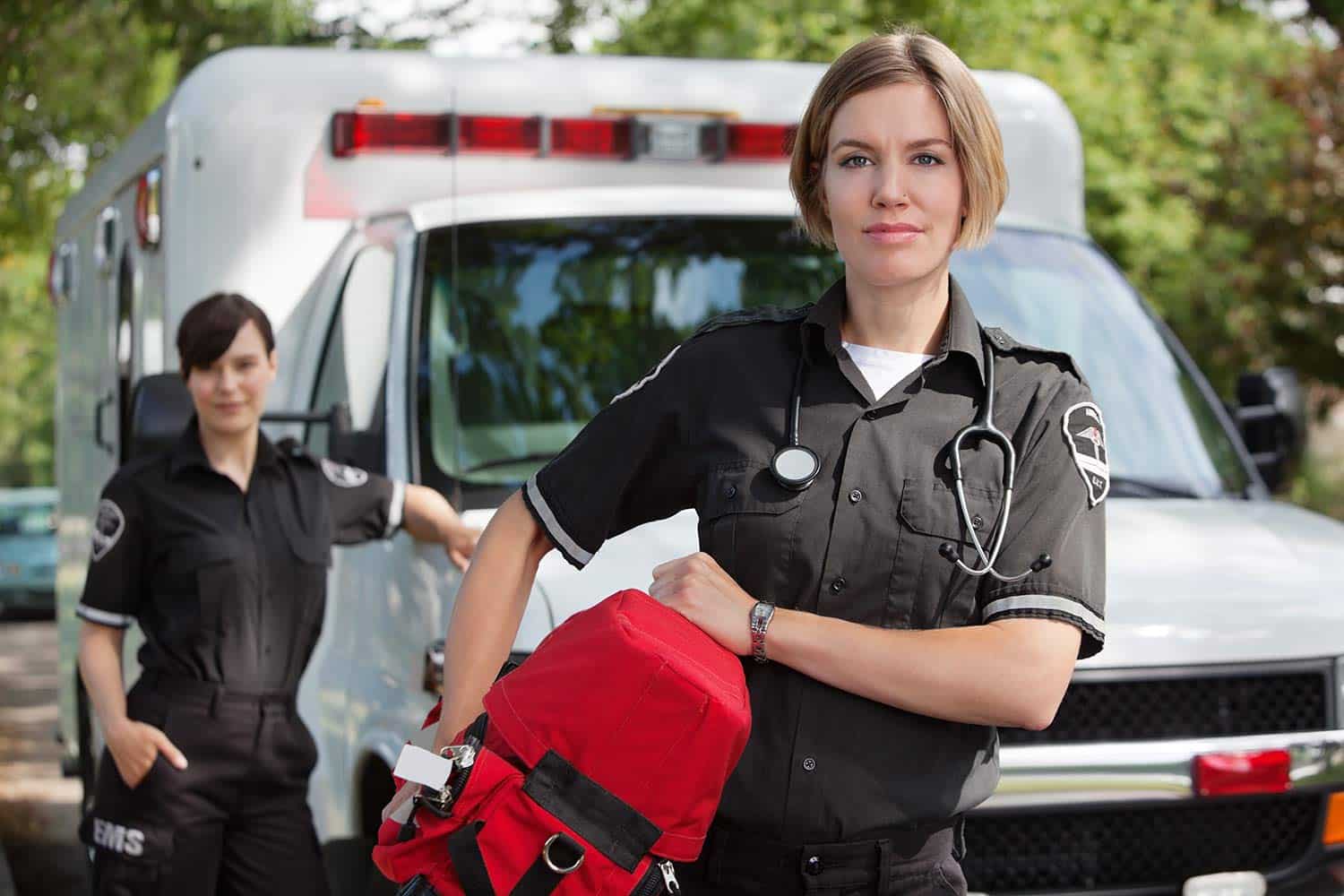 EMS professionals standing in front of an ambulance